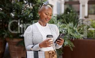 Every successful entrepreneur has a connection by their side. a young businesswoman using a cellphone while out in the city.