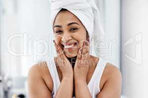 A smile to brighten up your day. a young woman going through her beauty routine at home.
