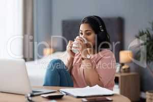 Time for a coffee break. a young woman working from home.
