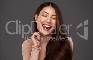 Life is better when youre smiling. an attractive young woman making a face in studio against a grey background.