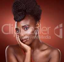 Fashion is a silent language. Cropped portrait of an attractive young woman posing in studio against a red background.