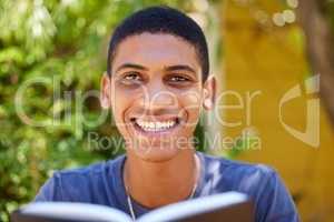 I love starting the day off with a bible verse. Cropped portrait of a handsome young man sitting alone outside and reading a book during the day.