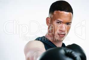 To become a champion, fight one more round. Portrait shot of a handsome young male boxer with vitiligo posing in studio.