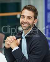 Im ready to get down to business. Cropped portrait of a handsome young businessman sitting alone in an office space during the day.