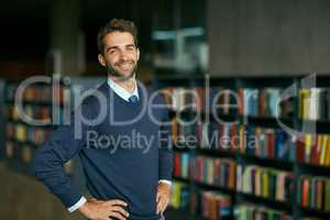 Self-education is a vital process in entrepreneurship. Cropped portrait of a handsome young businessman standing with his hands on his hips in an empty library.