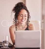 Everything sure is simpler with the help of the internet. a young woman sitting with her laptop at home.