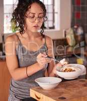 Its not about how much you eat, its what you eat. a young woman eating breakfast at home.