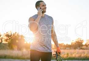 I hope the equipment I ordered arrives on time. a young man taking a phone call at sunset while in his garden.