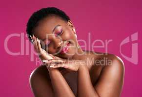 A smile a day keeps the sadness away. Studio shot of a beautiful young woman posing against a pink background.