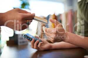 Make smart financial choices. a customer giving her card to make a payment in a store.