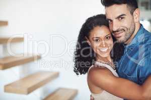 Hugging, love and affection couple loving, happy and smiling. Interracial boyfriend and girlfriend bonding together, dating and feeling positive. Portrait of cheerful married man and woman embracing