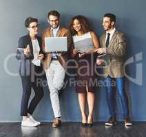 Group or team of business people working and browsing with wireless technology in studio against a grey background. Digital marketing colleagues networking online to advertise a startup company