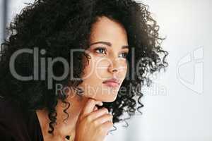 Beautiful, stunning and attractive female fashion designer thinking in a busy workshop or studio. Closeup of a young fashion creative contemplating and thoughtful while sitting inside an office