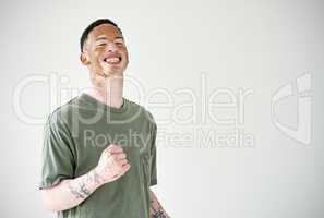 Choose to be optimistic - it just feels better. Studio shot of a young man with vitiligo cheering against a white background.