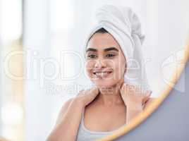 A bodycare routine is a great way to relive stress. attractive young woman admiring herself in the mirror.