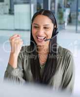 Big sales means bagging a big commission. a young call centre agent cheering while working in an office.