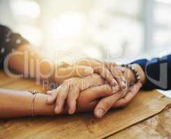 Holding hands showing care, love and support between friends, couple or family. People comforting, giving affection and embracing friendship with a hand gesture and touch during a difficult time