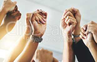 Teamwork, community and support with fists of power, protest hands joined together solidarity. Closeup of a group of people working together to achieve success. Teamwork, collaboration and unity