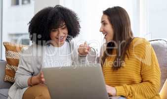 As besties, they share the same interests. two young women using a laptop together at home.