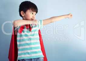 Hes a brave little boy. an adorable little boy pretending to be a superhero while playing at home.