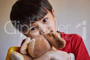 Childhood is the most beautiful of all lifes seasons. Portrait of an adorable little boy playing with his stuffed toys at home.