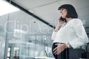 Wait, what. an attractive pregnant businesswoman standing alone in the office and feeling stressed while using her cellphone.