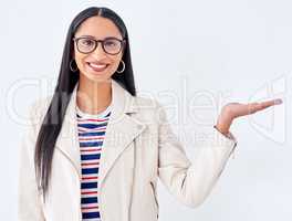 Heres whats on offer. Studio portrait of a young woman gesturing to copyspace against a white background.