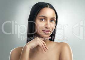 If youre looking for perfect skin, look no further. a beautiful young woman with flawless skin posing against a grey background.