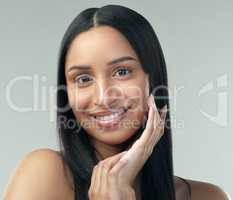 Skin thats cared for will always look beautiful. a beautiful young woman with flawless skin posing against a grey background.