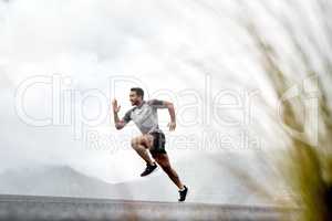 Persistence can change failure into extraordinary achievement. a sporty young man running outdoors.