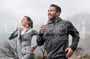 Trail running improves every element of your fitness. a sporty young man and woman running together outdoors.