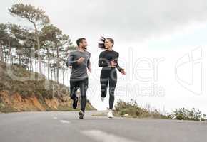 Were each others source of motivation. Full length shot of two young athletes bonding together during a run outdoors.