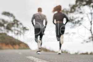 Count your breath, not your steps. Full length shot of two unrecognizable athletes bonding together during a run outdoors.