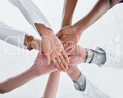 Joining together for the sake of quality healthcare. Closeup shot of a group of medical practitioners joining their hands together in a huddle.