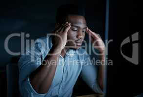 Pressure rising, productivity falling. a young businessman looking stressed while using a computer during a late night at work.