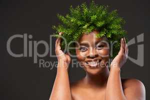 Make happiness as routine as your beauty regime. Studio shot of a beautiful young woman wearing a leaf wreath on her head against a grey background.