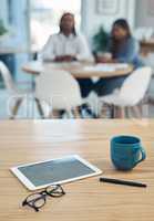 Forecasting big profits. Closeup shot of a digital tablet and other items on a table in an office.