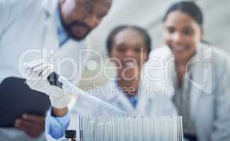 Action is the first step to finding a cure. a group of scientists conducting research in a laboratory.