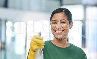 No stress, our cleaning service will handle the mess. Portrait of a young woman cleaning a modern office.