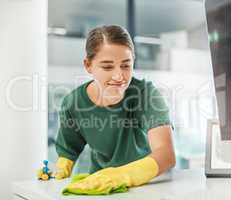 No mess, no stress. a young woman cleaning a modern office.