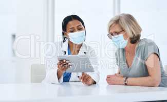 Expert diagnosis that patients can depend on. a young doctor using a digital tablet during a consultation with a senior woman.