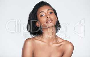 Make flawless looking skin a habit. a beautiful young woman posing against a white background.