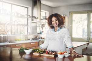 Wellness, cooking and a healthy lifestyle at home with a happy woman starting a weight loss journey. Portrait of a female smiling preparing a nutritious meal with organic vegetables in a kitchen