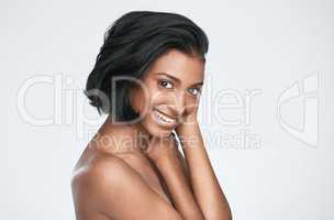 Her beauty is the first thing people notice. a beautiful young woman posing against a white background.