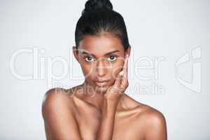 Less makeup, more of that natural glow. a beautiful young woman posing against a white background.