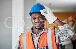 Get your helmets on, weve got work to do. Portrait of a confident young man working at a construction site.