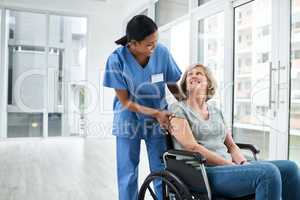Work is where the heart is. a young nurse caring for a senior woman in a wheelchair.