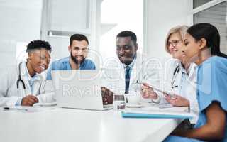 This could be the way forward. a group of medical practitioners using a laptop during a meeting in a hospital boardroom.