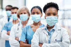 The heroes on the front lines of the pandemic. Portrait of a group of medical practitioners wearing face masks while standing together in a hospital.