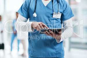 Mapping the way forward with smart tech. Closeup shot of an unrecognisable medical practitioner using a digital tablet in a hospital.